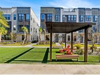 Modern townhome exteriors with lush green space, pergola, and seating area at 2138 Whitney Marsh Aly, Orlando, FL 32804