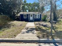 Charming blue single-story home with a well-maintained front yard and inviting entrance at 2204 Ernest St, Kissimmee, FL 34741