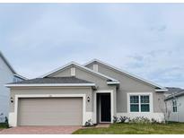 One-story home with attached garage and neutral color palette at 366 Switchgrass Loop, Minneola, FL 34715