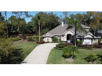 Stunning single-story home with lush landscaping and a circular driveway, perfect for suburban living at 4901 Shoreline Cir, Sanford, FL 32771