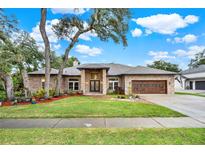 Charming single-story brick home with a well-manicured lawn and a large garage at 250 Shady Oaks Cir, Lake Mary, FL 32746