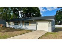 Charming single-story home featuring a brick facade, a well-manicured lawn, and an attached garage at 1801 James St, South Daytona, FL 32119