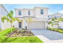 Charming two-story home featuring a beautifully landscaped front yard and a two-car garage at 1697 Kona Ln, Davenport, FL 33897