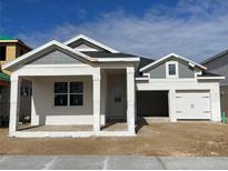 Craftsman style home with gray siding, white trim, and a two-car garage at 16875 Muskgrass Dr, Winter Garden, FL 34787