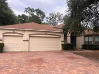Charming single-story home featuring a brick driveway and a three-car garage at 284 Pinestraw Cir, Altamonte Springs, FL 32714