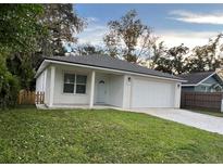 Newly constructed home with a two-car garage and a well-manicured lawn at 912 W 5Th St, Lakeland, FL 33805