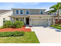 Two-story house with a two-car garage and well-manicured lawn at 2275 Cathedral Rock Dr, Kissimmee, FL 34746