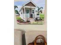 Charming tiny home with a covered front porch, offering a cozy and inviting curb appeal at 575 2Nd St, Oviedo, FL 32765