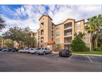 Tan three-story apartment building with ample parking at 1371 Tuscan Ter # 3204, Davenport, FL 33896