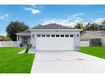 Newly renovated one-story home with a two-car garage and manicured lawn at 805 Nelson Dr, Kissimmee, FL 34758