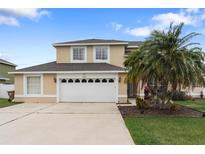 Charming two-story home with a two-car garage and a well-manicured lawn at 2691 Hawthorne Ln, Kissimmee, FL 34743