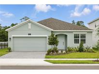 Charming one-story home featuring a neutral color scheme, brick driveway, and well-manicured lawn at 2585 Cavanaugh Dr, Orlando, FL 32817