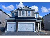 Two-story home with a two-car garage and a gray exterior, featuring white trim and a well-manicured lawn at 1181 Basalt Ln, Sanford, FL 32771