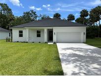 Charming single-story home with a well-manicured lawn and a spacious two-car garage at 282 Kimble Ave, Oviedo, FL 32765