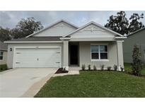 Charming single-story home featuring a two-car garage, landscaped yard, and craftsman-style architectural details at 5441 Hayloft Dr, Apopka, FL 32712