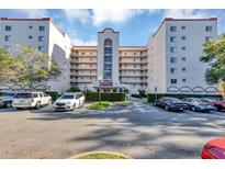 Low-rise building shows well-maintained landscaping and parking in front of the building at 1150 Carmel Cir # 201, Casselberry, FL 32707