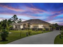 Charming single-story home features a screened porch, lush landscaping, and a long driveway leading to the house at 18920 Overton St, Orlando, FL 32833