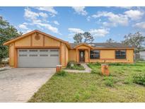 Charming single-story home with a well-maintained yard and a spacious two-car garage at 3186 Mapleshade St, Deltona, FL 32738