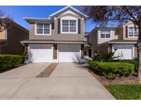 Two-story townhome with two-car garage and landscaped front yard at 5058 Maxon S Ter # 108, Sanford, FL 32771