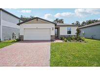 One-story house with a brick driveway and landscaped lawn at 5186 Minneola Ln, Saint Cloud, FL 34772