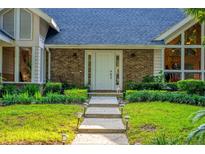 Charming home featuring a brick facade, front yard landscaping, and a welcoming front door at 530 Estates Pl, Longwood, FL 32779