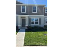 Charming two-story home with gray trim and lush green lawn in a Gathering-friendly community at 6134 Galloping Dr, Apopka, FL 32712