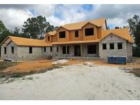 New construction home featuring a two-story layout, block construction and a covered porch at 405 Long And Winding Rd, Howey In The Hills, FL 34737