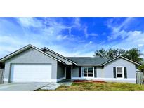 Charming single-story home with a two-car garage and well-manicured lawn at 2870 Chalmer St, Deltona, FL 32738