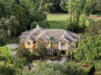 Expansive estate home with a tile roof, lush landscaping, and an over-sized driveway at 3499 Rockcliff Pl, Longwood, FL 32779
