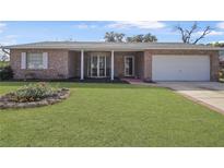 Charming brick home featuring a well-manicured lawn and an attached one car garage at 725 Mahogany Ln, Altamonte Springs, FL 32714