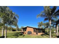 Ranch-style home with screened porch and lush landscaping at 6799 Chad Jason Rd, Saint Cloud, FL 34773