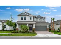 Charming two-story home featuring a gray color scheme, manicured lawn, and attached two-car garage at 5249 Stone Ridge Pl, St Cloud, FL 34771