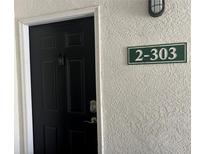 Modern condo front door with keyless entry and security camera at 2740 Maitland Crossing Way # 2-303, Orlando, FL 32810