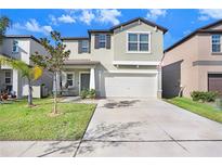 Two-story house with a two-car garage and landscaped lawn at 1536 Landmark Dr, Lakeland, FL 33801