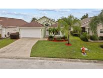 Charming single-Gathering home featuring a well-manicured lawn and attached two-car garage at 246 Kimberly Point Dr, Davenport, FL 33837