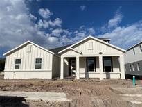 Charming single-story home featuring bright white siding, dark window shutters, and a welcoming front porch at 2564 Hawks Overlook Pl, Oviedo, FL 32765