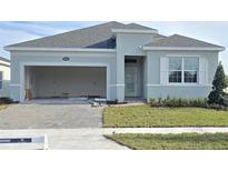 New construction home with two-car garage and landscaping at 2643 Great Heron Ave, Saint Cloud, FL 34771