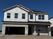 Two-story home featuring an attached two-car garage and a classic design under construction at 2684 Great Heron Ave, Saint Cloud, FL 34773