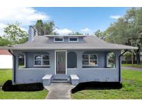 Charming single Gathering home featuring a covered front porch and a well-maintained, grassy lawn at 500 N 13Th St, Leesburg, FL 34748