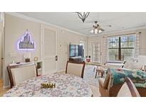 Cozy living room featuring tile floors, a ceiling fan, and comfortable seating area at 907 Charo Pkwy # 923, Davenport, FL 33897