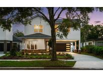Inviting two-story home with a modern front yard landscape and a convenient two-car carport at 1020 W Princeton St, Orlando, FL 32804