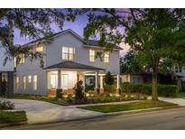 Inviting two-story home with a welcoming front porch, professional landscaping, and mature trees in a desirable neighborhood at 1020 W Princeton St, Orlando, FL 32804