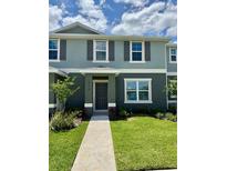 Charming two-story home with a well-manicured lawn and inviting entrance at 6118 Galloping Dr, Apopka, FL 32712