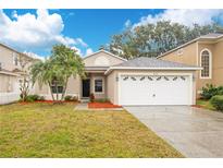 Charming one-story house with a two-car garage and well-manicured lawn at 623 Buckingham Dr, Oviedo, FL 32765