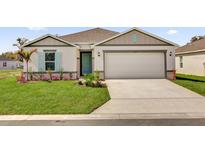 Charming single-story home featuring a well-manicured lawn, two-car garage, and stylish curb appeal at 5736 Thalia Rd, Lakeland, FL 33810