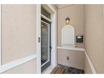 Inviting front entry featuring decorative glass door, stucco walls, and classic black hardware at 41 E Spruce St, Orlando, FL 32804