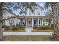 Charming two-story home with a welcoming front porch and manicured landscaping at 1338 Union Club Dr, Winter Garden, FL 34787