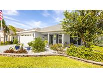 Charming single-story home with a well-manicured lawn and rock garden at 4245 Arlington Ridge Blvd, Leesburg, FL 34748