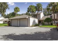 Charming home featuring an attached two-car garage and surrounded by mature trees and landscaping at 543 Warrenton Rd # 543, Winter Park, FL 32792