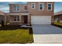 Charming two-story home featuring a welcoming front porch and a two car garage at 3558 Sandalwood Isle Way, Ocoee, FL 34761